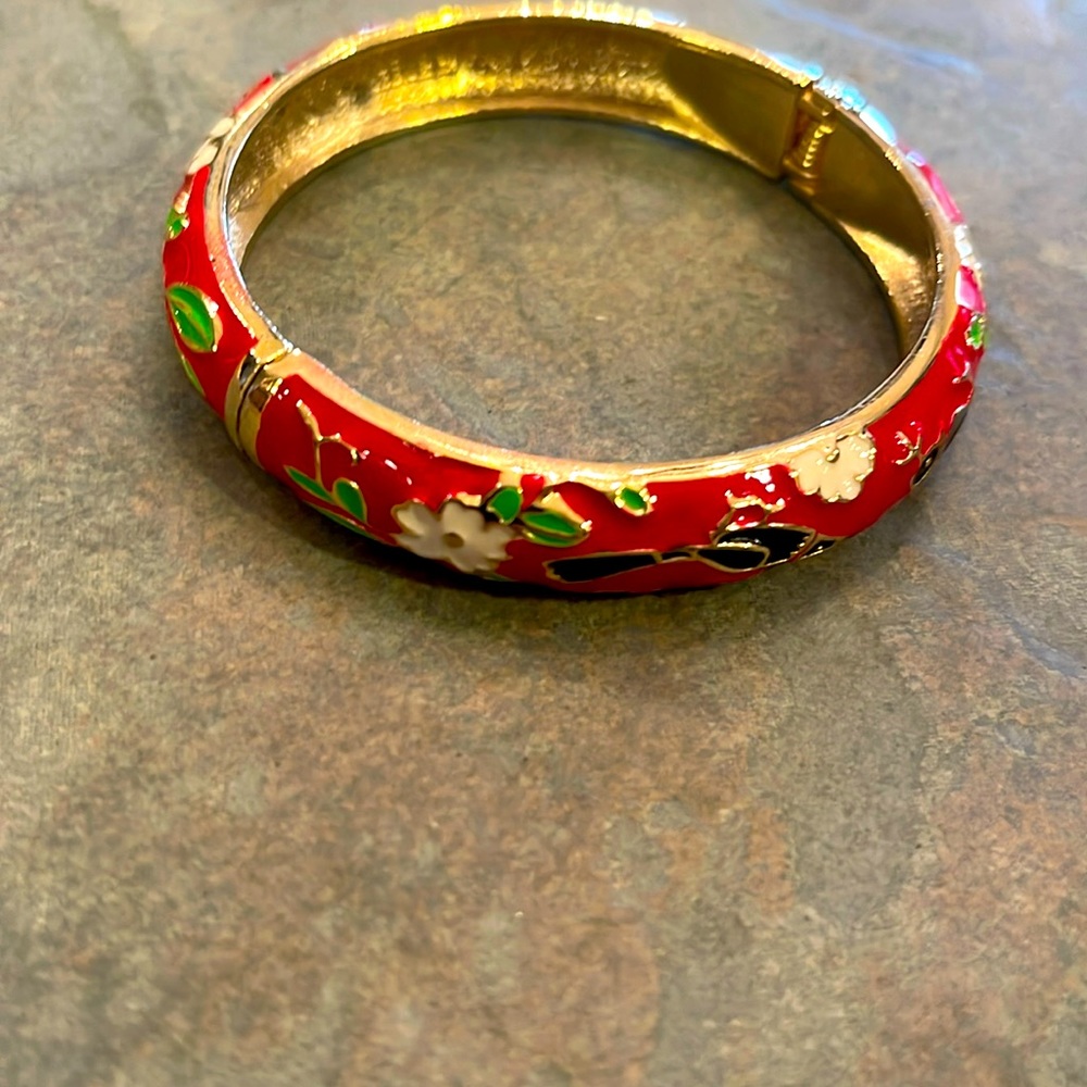 Red bracelet with floral pattern. One size